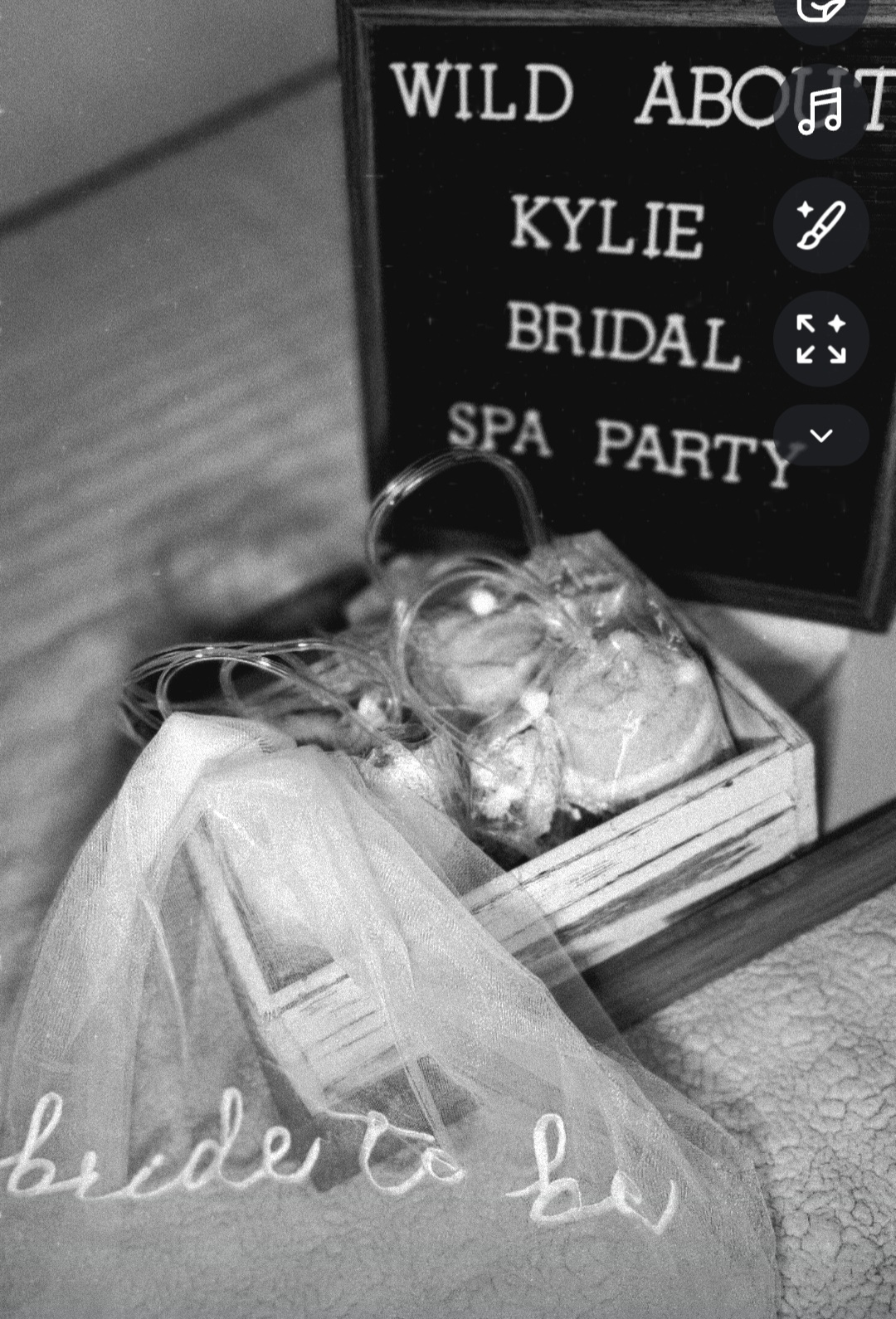 A box with a veil and flowers, and a sign reading 'WILD ABOUT KYLIE BRIDAL SPA PARTY'.