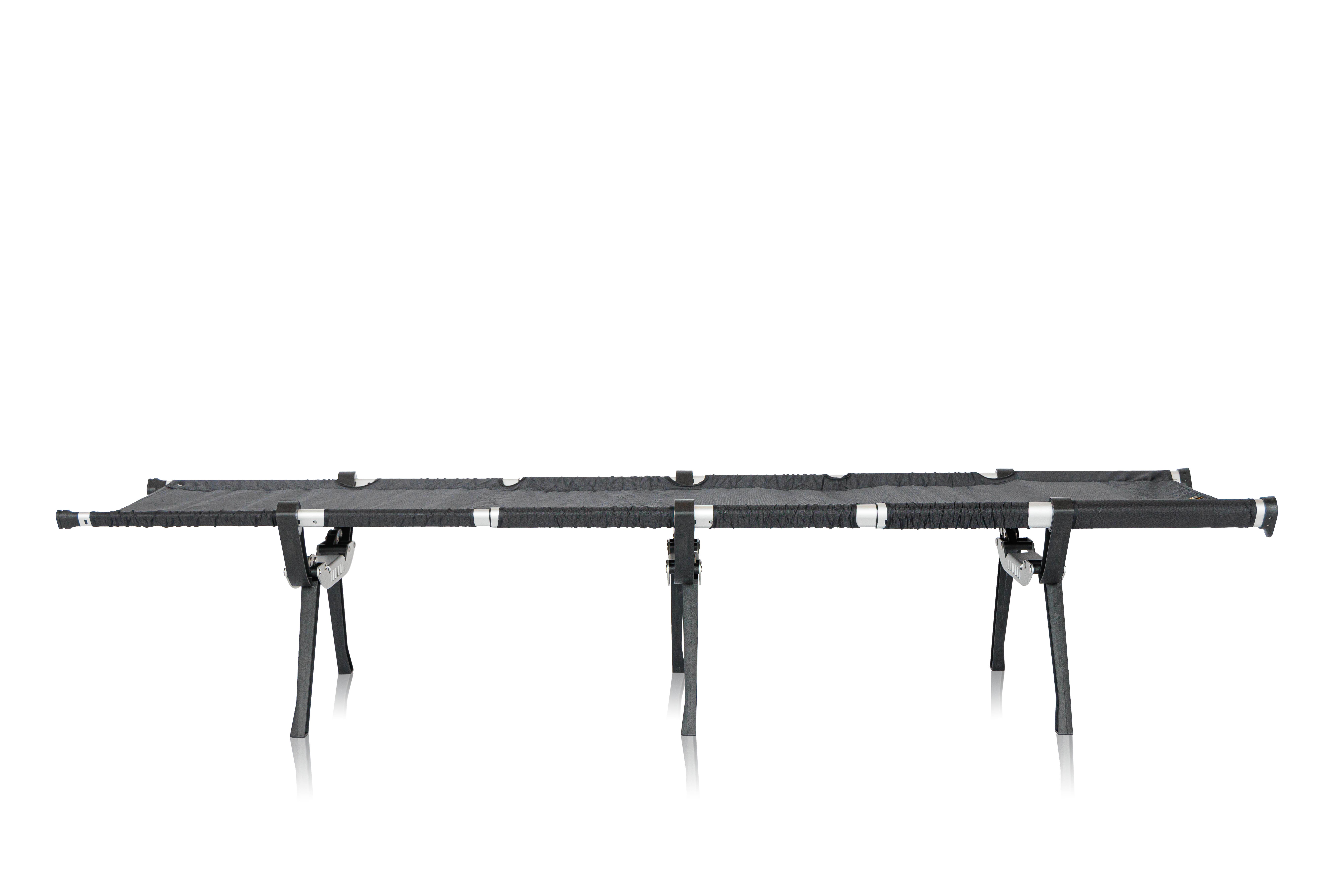 A long, black, portable workbench with adjustable legs and a textured surface, viewed from the side.