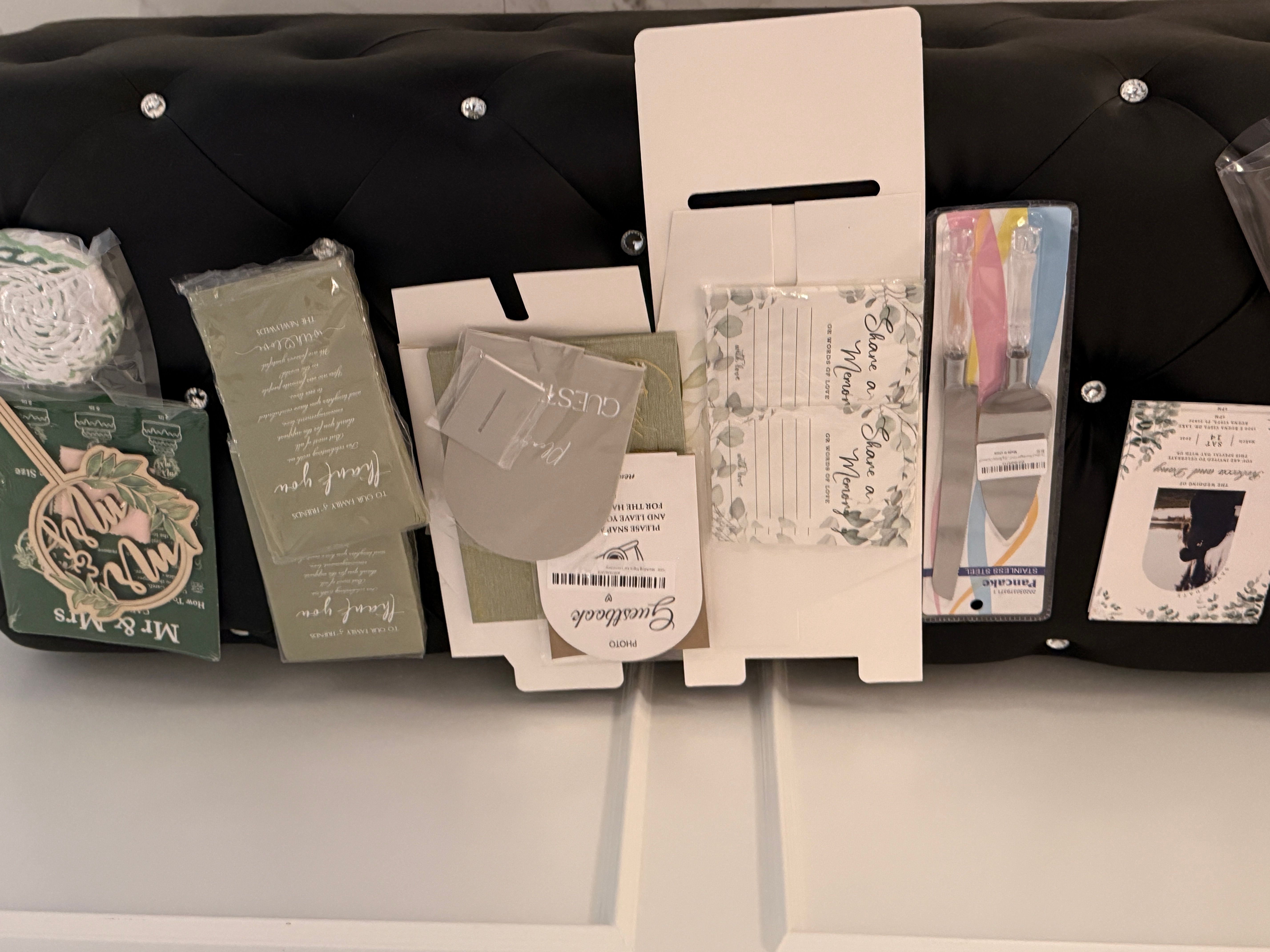 Various books and a framed picture on a black surface, with a white wall behind, viewed sideways.