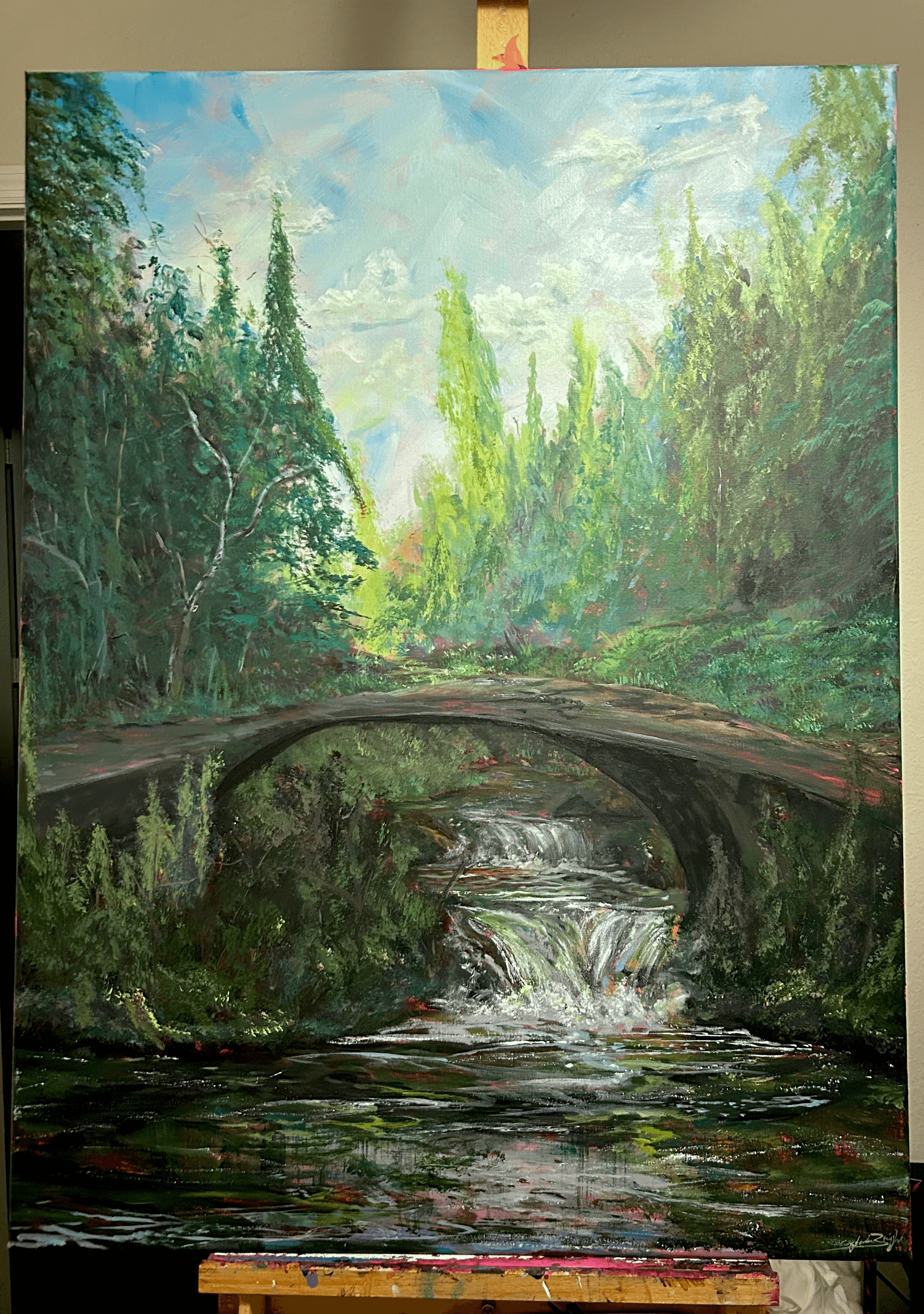 Landscape painting of a bridge over a river surrounded by trees and greenery, with a cloudy sky above.