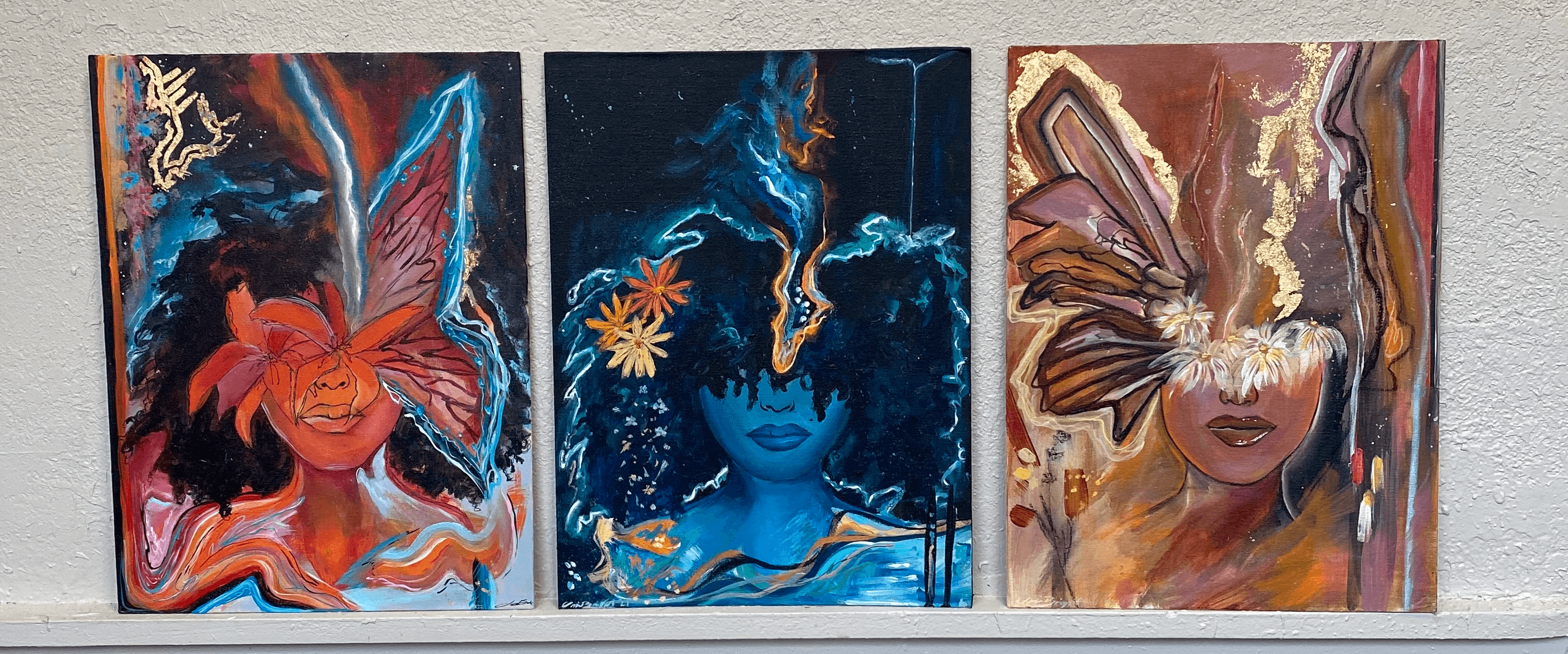 Three colorful abstract paintings featuring faces and vibrant patterns, displayed side by side on a wall.