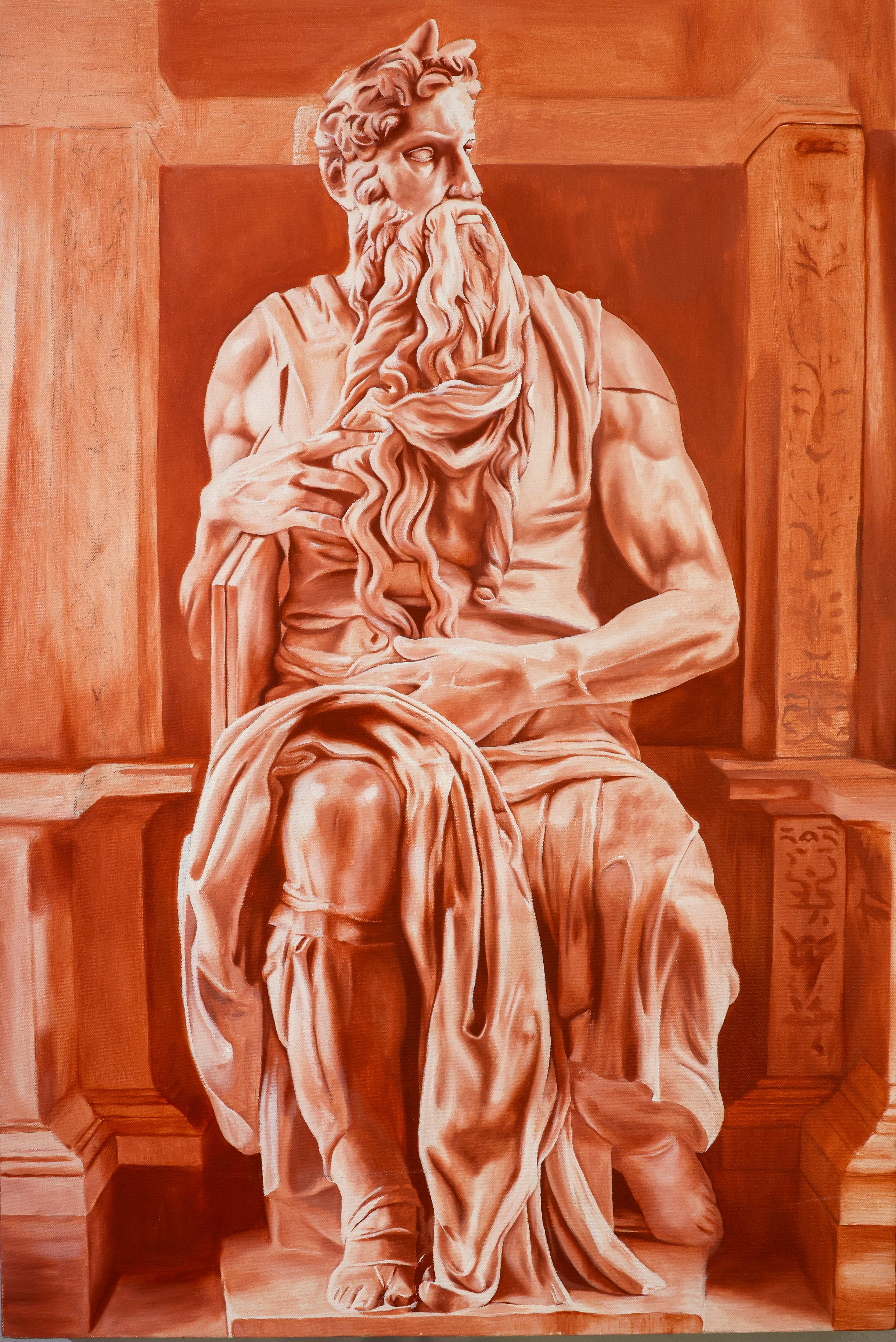 Statue of a seated bearded man with a flowing beard and draped clothing, sitting on a throne-like chair.