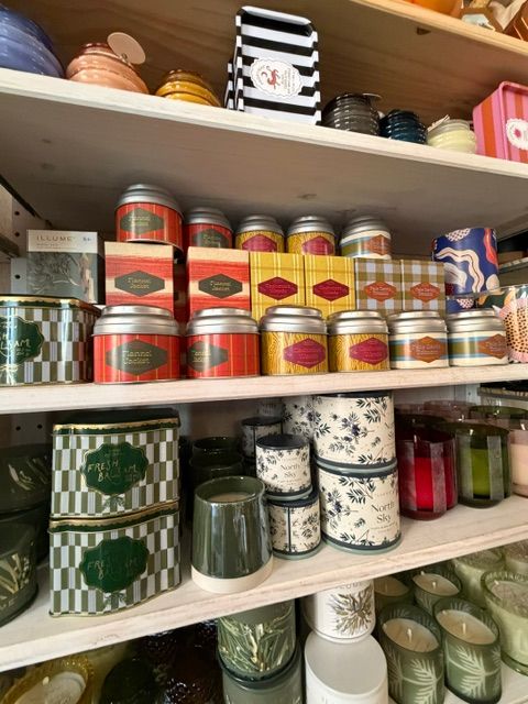 Display of colorful washi tapes and decorative boxes on a shelf, with various patterns and colors visible.
